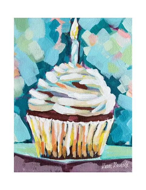 A cupcake topped with swirls of white frosting against a blue background.