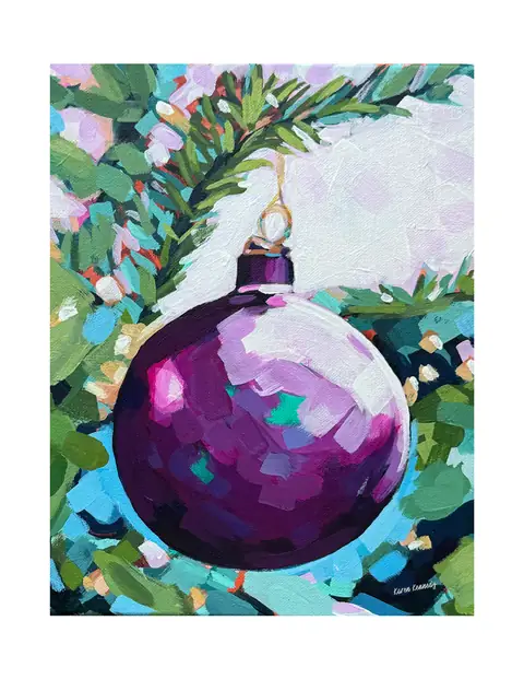 A purple Christmas ornament hanging among evergreen branches.